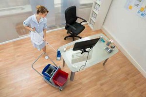 Female Janitor With Mop In Office